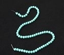 Round turquoise-magnesite beads.